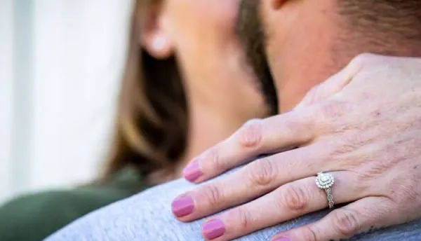 Wedding photography by Shield of Faith Marketing, a bride's ring resting on the groom's shoulder