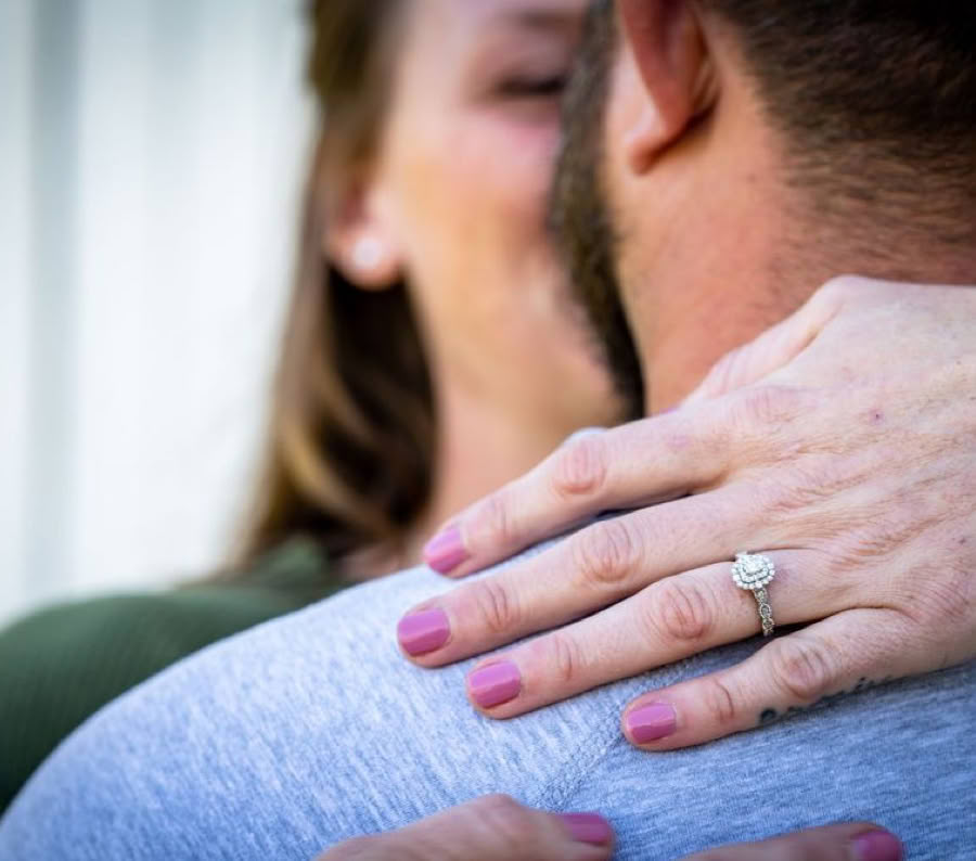 Wedding photography by Mark A Robey, a bride's ring resting on the groom's shoulder